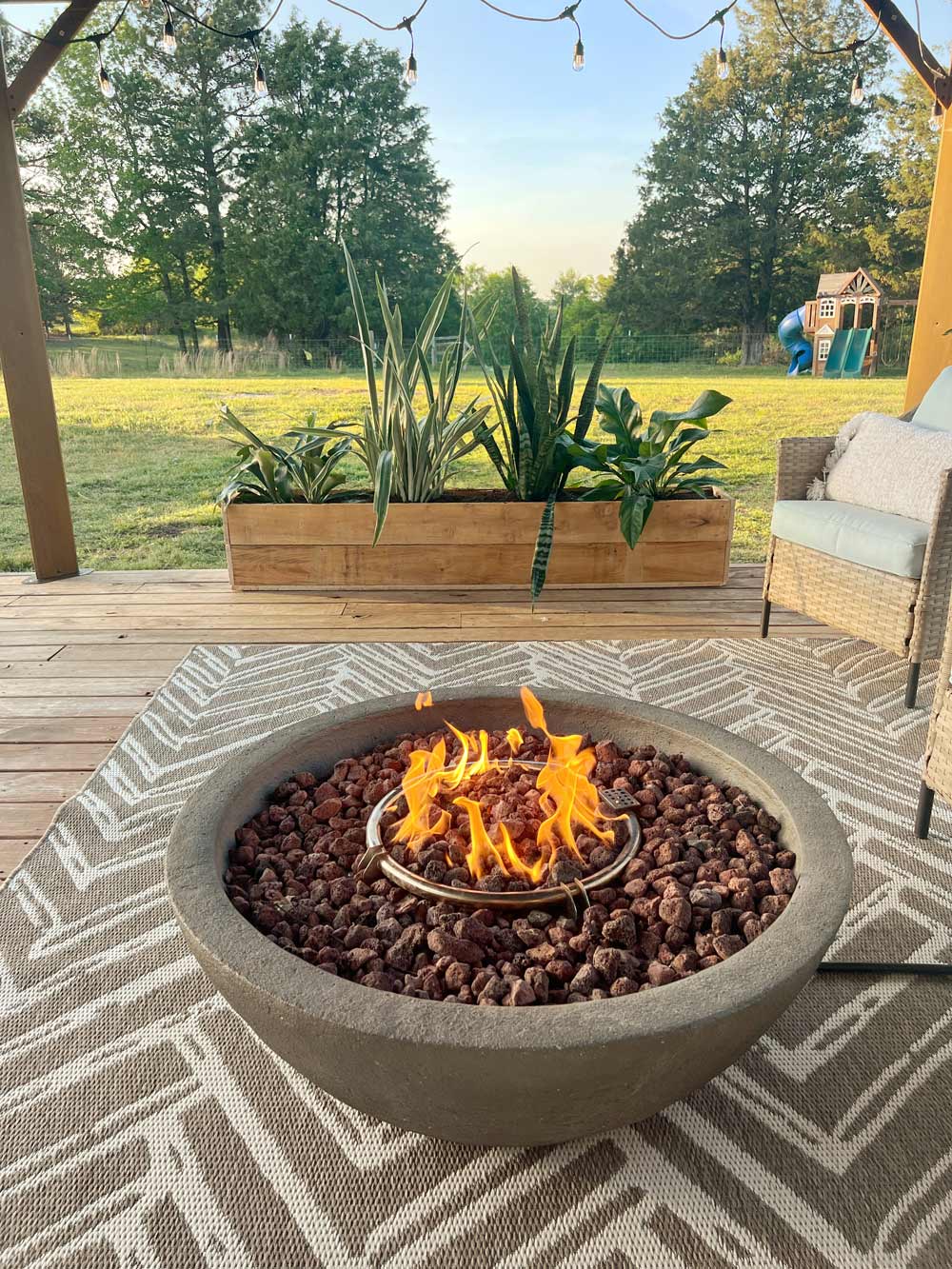 A firepit in front of custom wooden planter. A firepit in front of custom wooden planter.