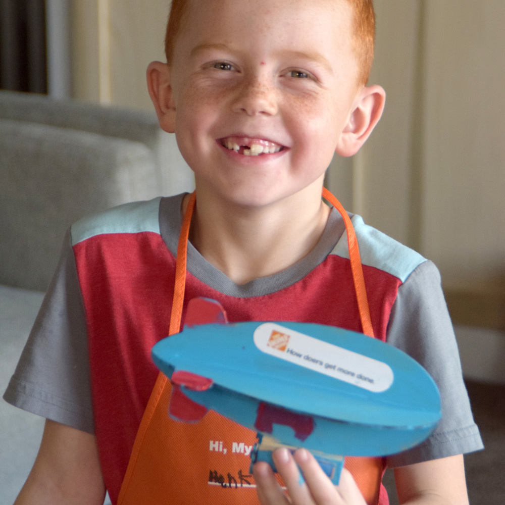 smiling boy with blue airship