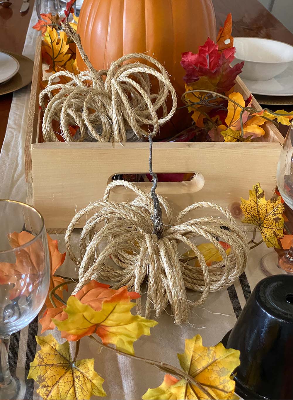 Wooden crate filled with thanksgiving decorations.
