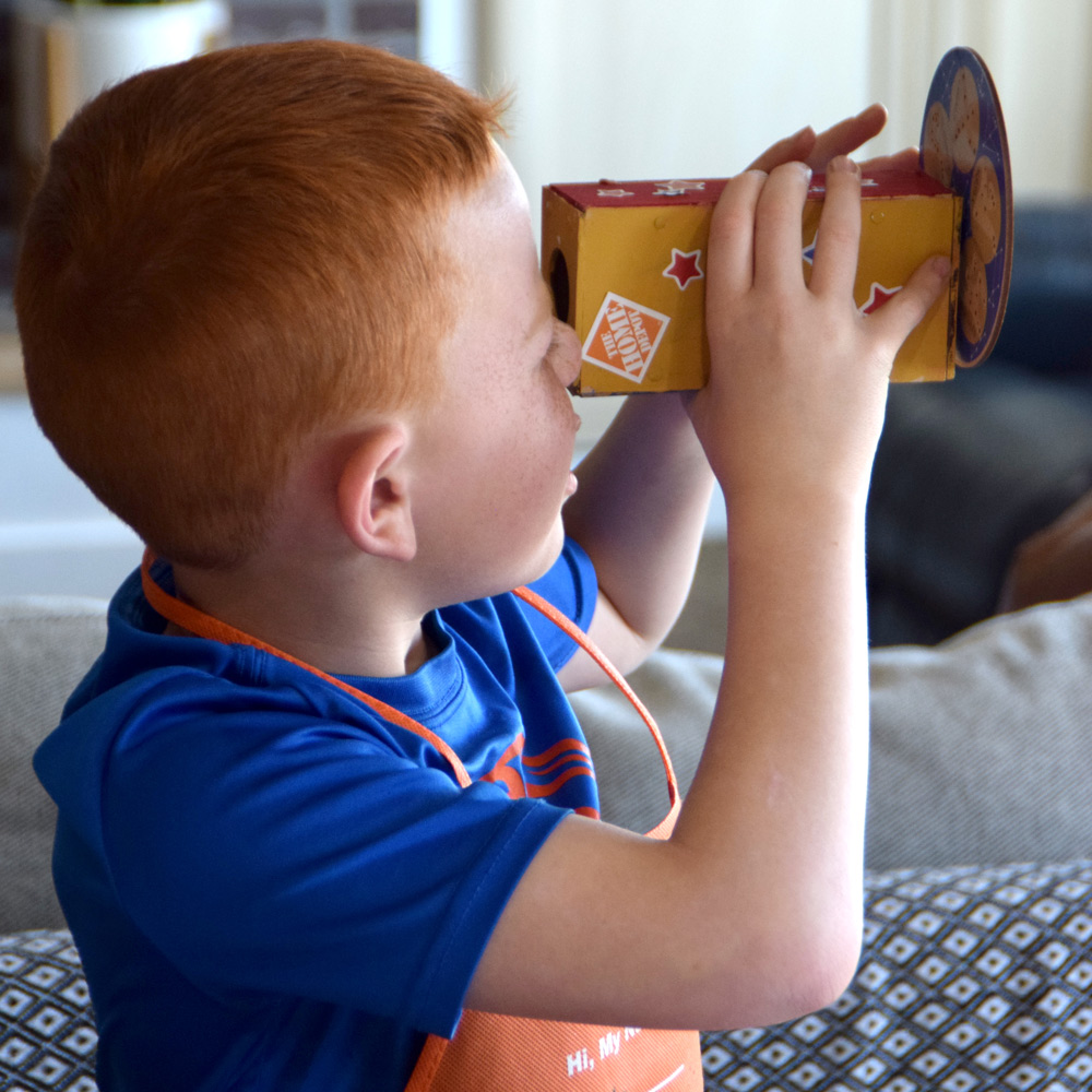 Boy looking through constellation viewer