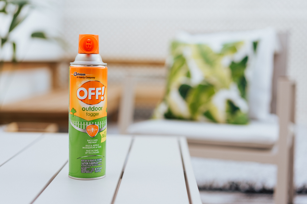 A can of OFF! Spray on a table, with a chair and banana leaf-patterned pillow in the background.