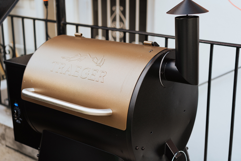 A black and gold Traeger grill.