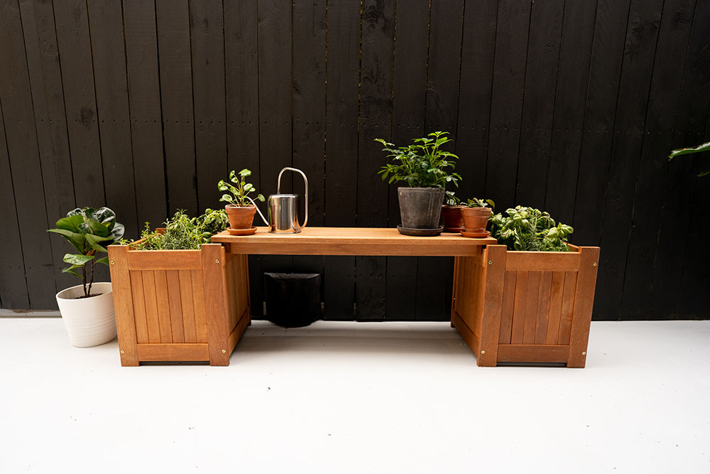 A small bench surrounded and covered by plants. A small bench surrounded and covered by plants.