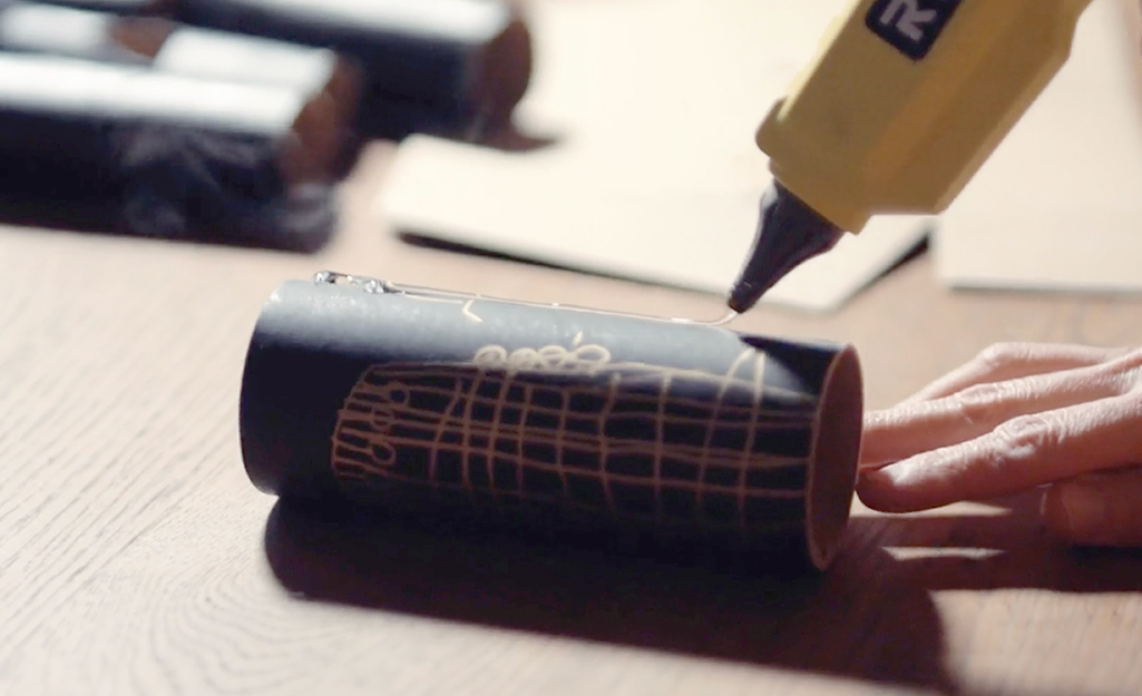 A person gluing a decorated castle piece. A person gluing a decorated castle piece.