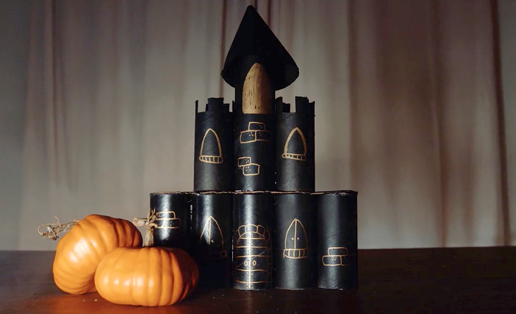 A completed haunted castle with pumpkins on a table. A completed haunted castle with pumpkins on a table.
