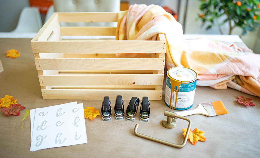 Supplies, including a crate and casters laid out on a table.