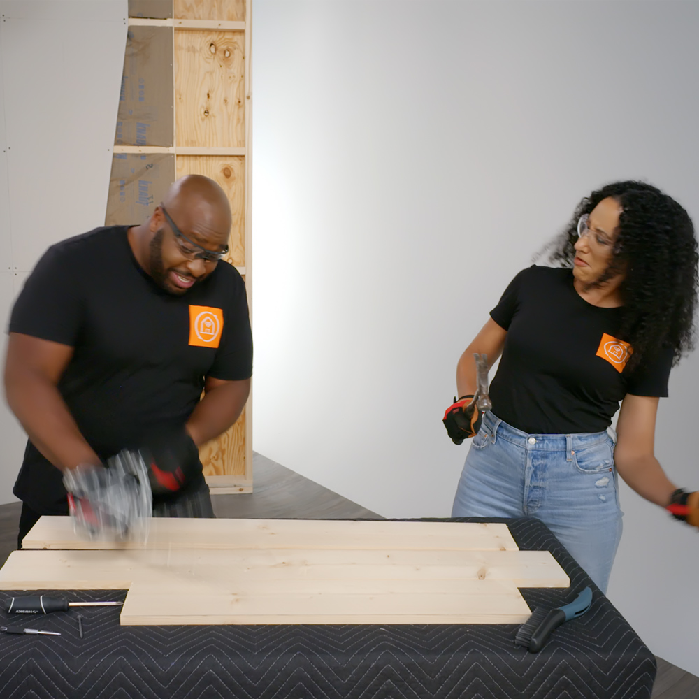 Man and woman cutting wood panels. Man and woman cutting wood panels.