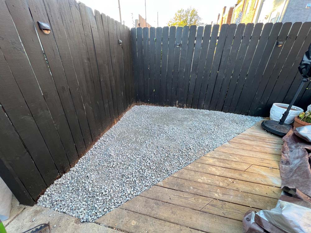 Corner of outdoor patio covered with grey gravel
