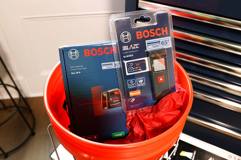 Two Bosch measuring products sitting in a decorated bucket.