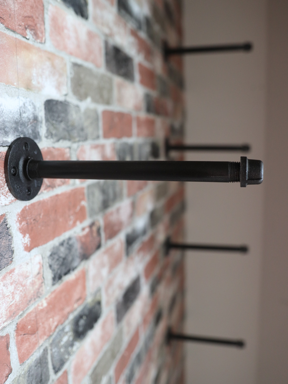 A group of black pipes assembled to a wall. A group of black pipes assembled to a wall.