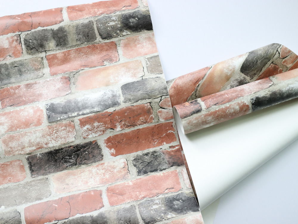 A roll of brick peel-and-stick wallpaper. A roll of brick peel-and-stick wallpaper.