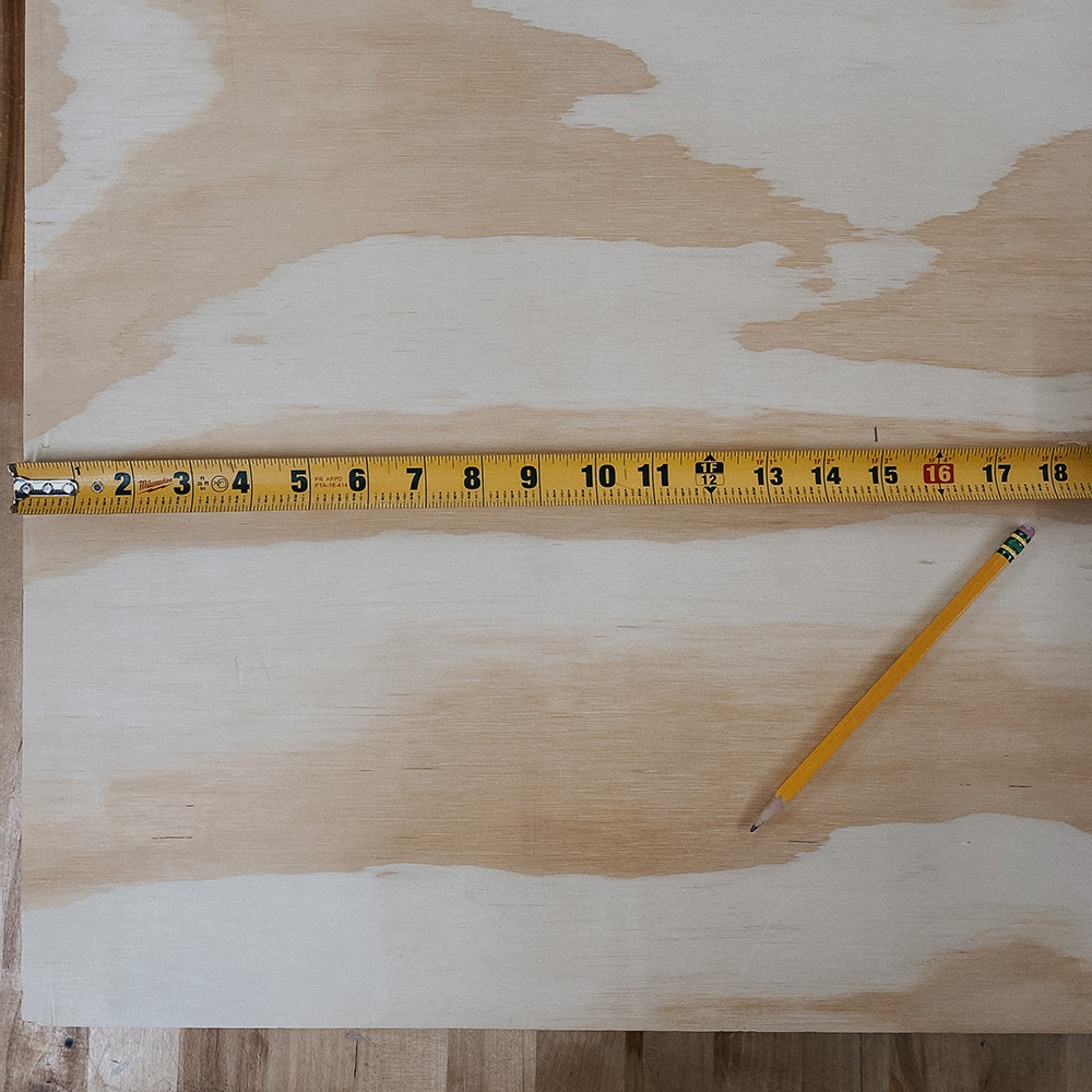 Tape measure and pencil on a marked piece of wood.