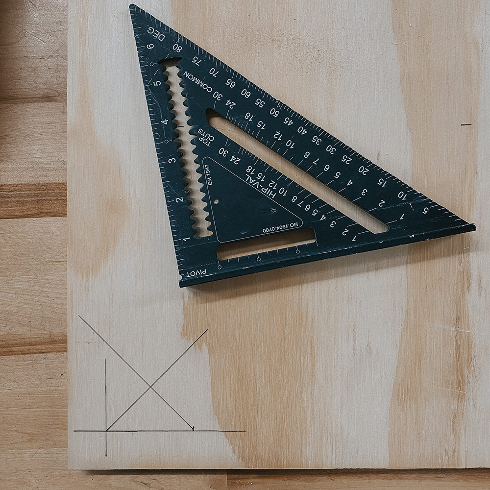 Protractor on a piece of marked wood.