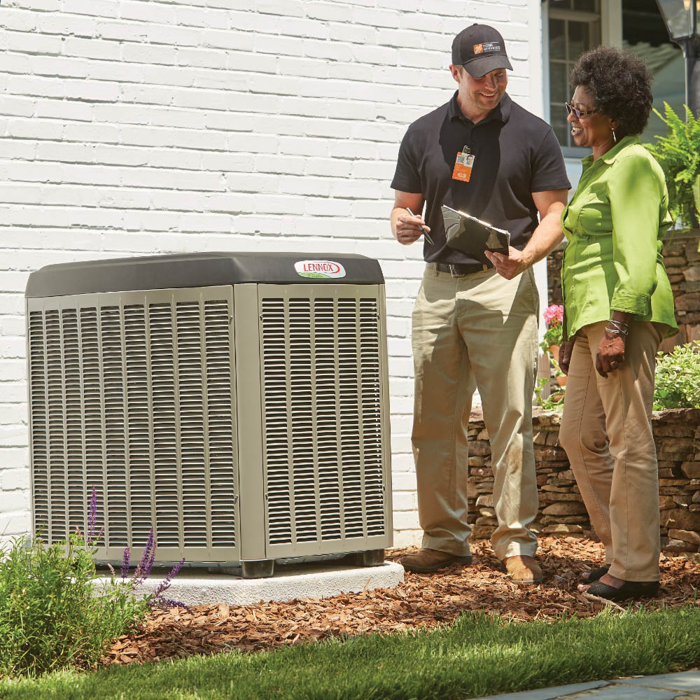 A Pro Services Employee shares details with a customer about their new AC condenser.