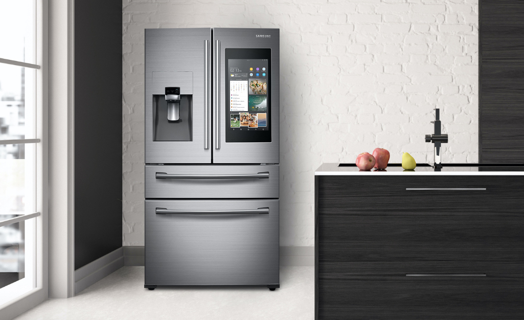 A smart refrigerator stands in a kitchen.