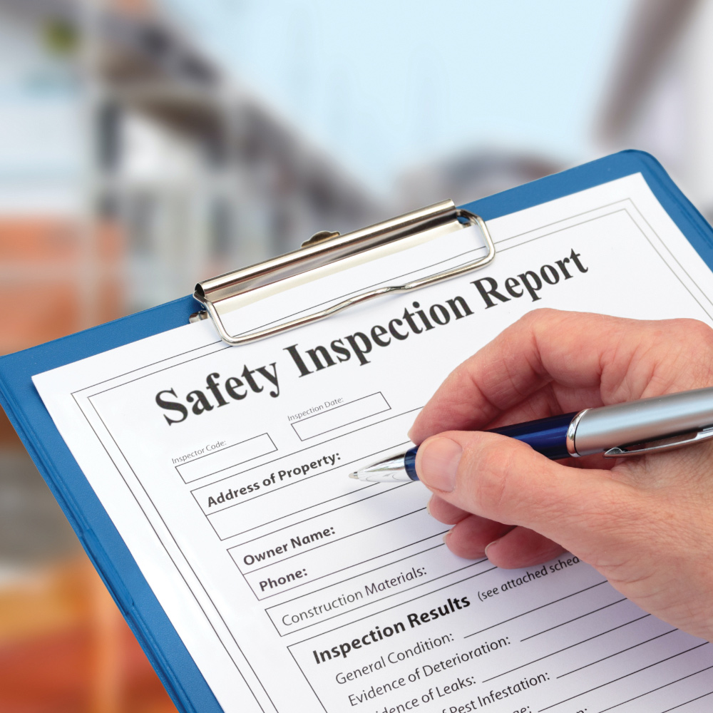 A person uses a workplace safety checklist.