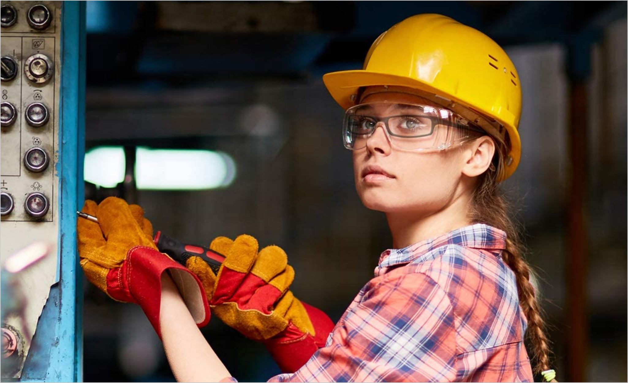 A worker wears safety goggles over her glasses.