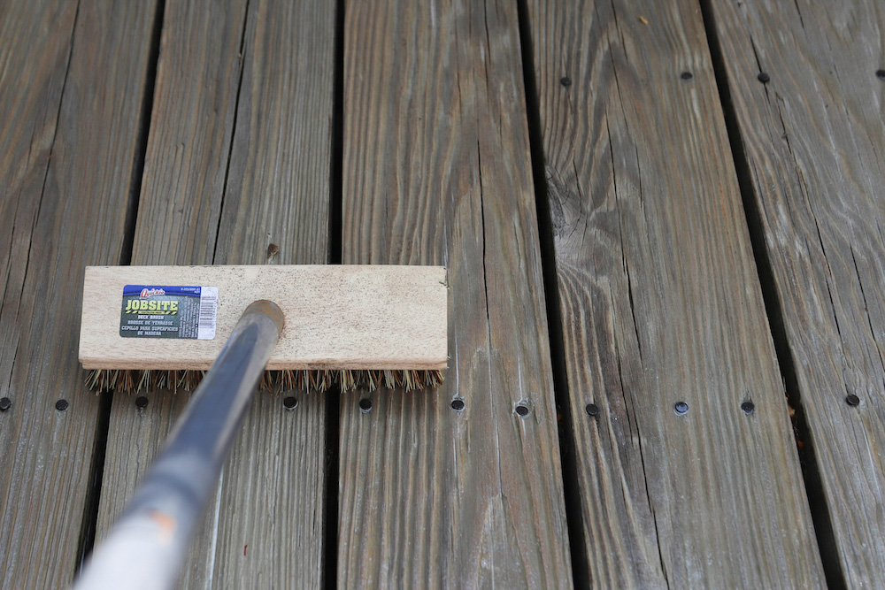 A bristle brush scrubbing a deck floor. A bristle brush scrubbing a deck floor.