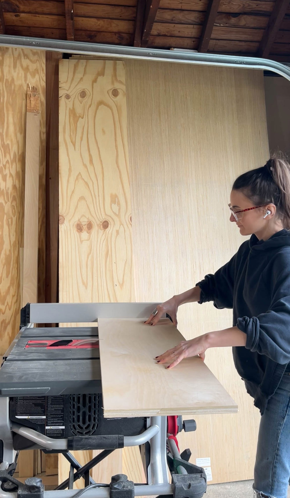 Person using saw to cut large piece of wood. Person using saw to cut large piece of wood.
