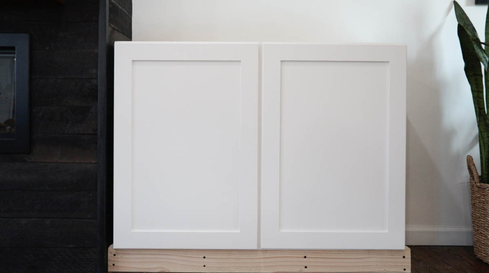 White wall cabinets on top of the custom base.