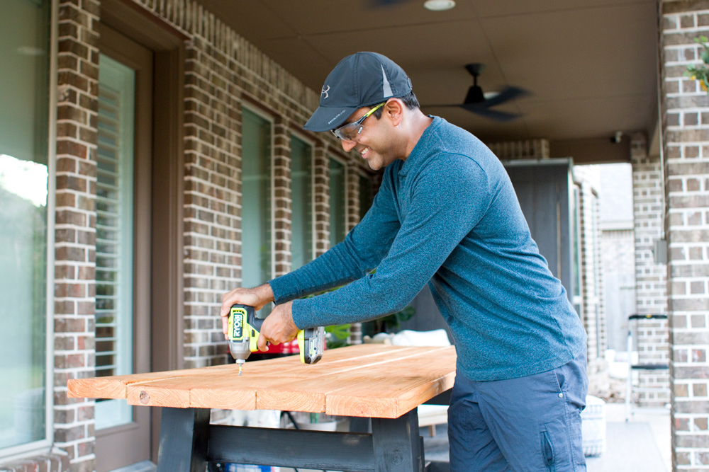 A person building a table. A person building a table.