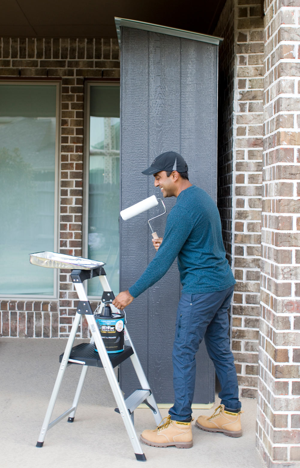 A person painting a shed. A person painting a shed.
