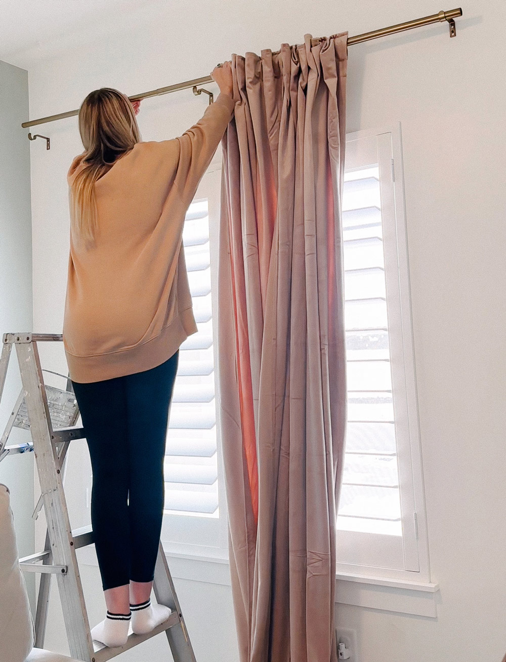 A person adding curtains.