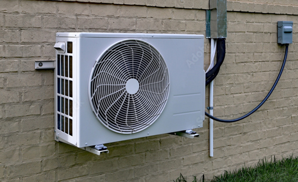 A heat pump attached to the air conditioning system of a house.