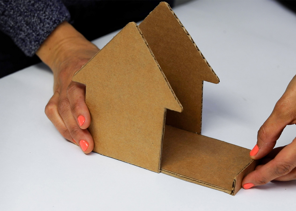 Shot of person attaching cardboard pieces together