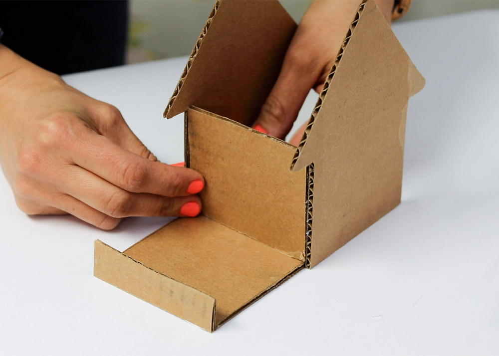 Shot of person attaching cardboard pieces together