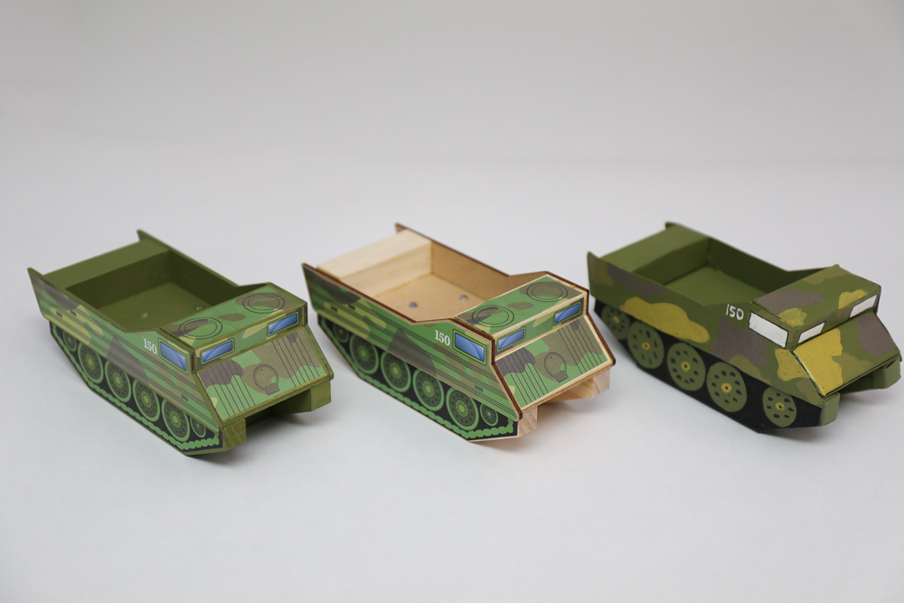 Three variations of painted DIY cardboard vehicles