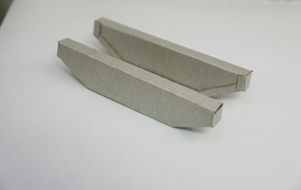 two folded and glued cardboard vehicle track parts