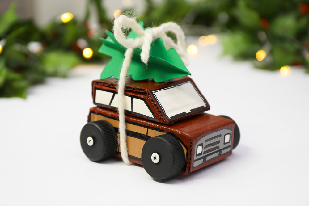 a completed and painted cardboard Christmas car