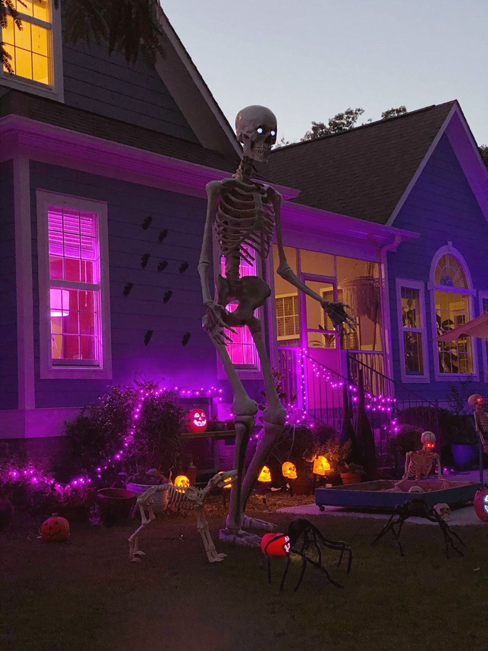A home decorated with glowing purple lights for Halloween.