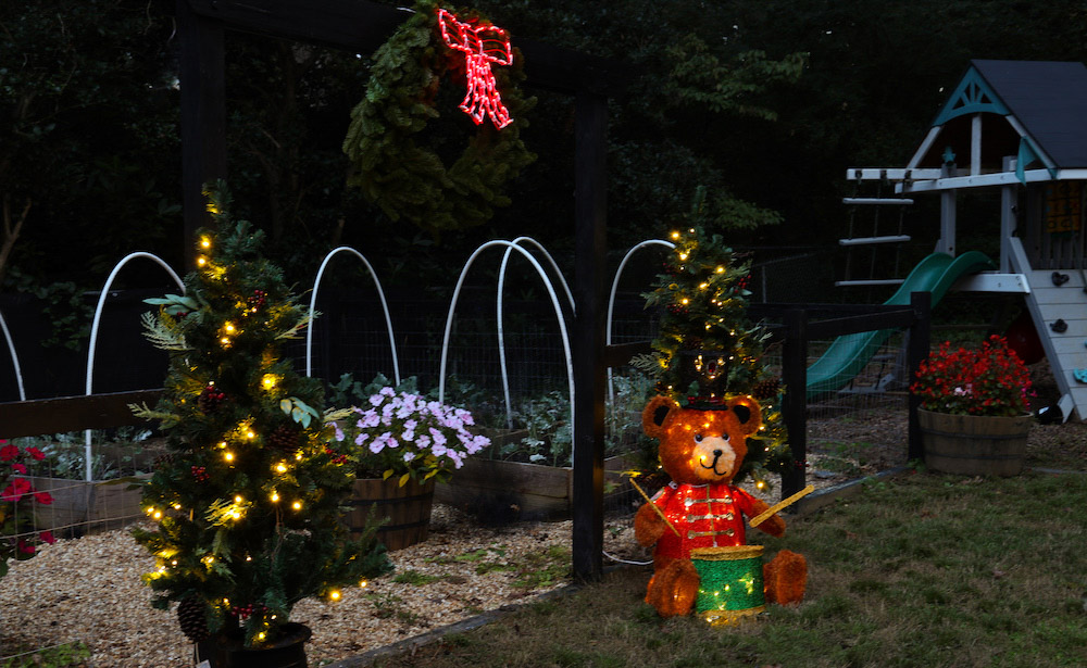 Garden styled with pre-lit trees, LED teddy bear and pre-lit wreath