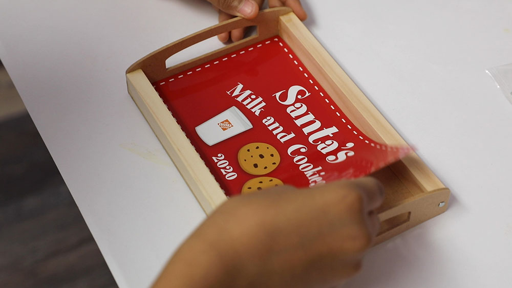A Santa's Milk and Cookies sticker is applied to the finished wood tray.