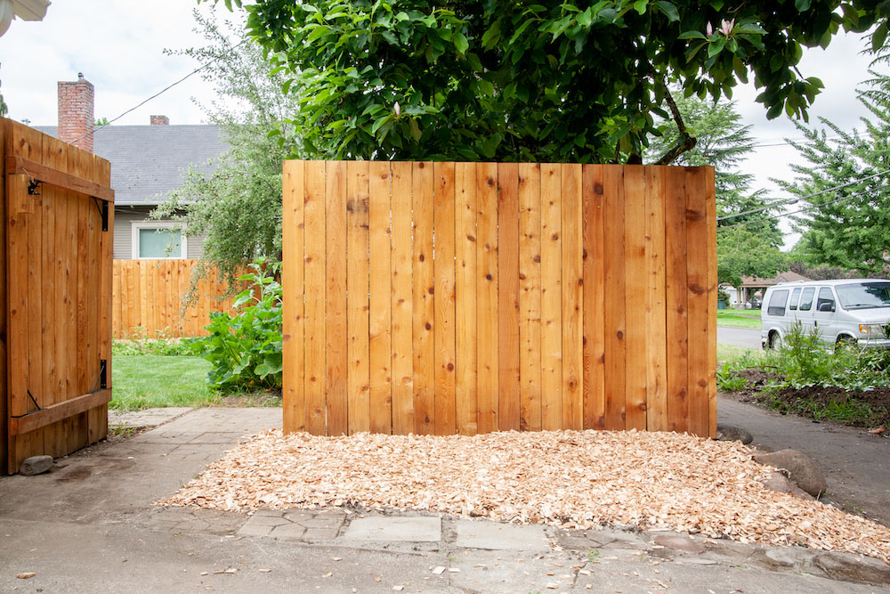 The side of a wooden fence that has been cleaned and waterproofed. The side of a wooden fence that has been cleaned and waterproofed.