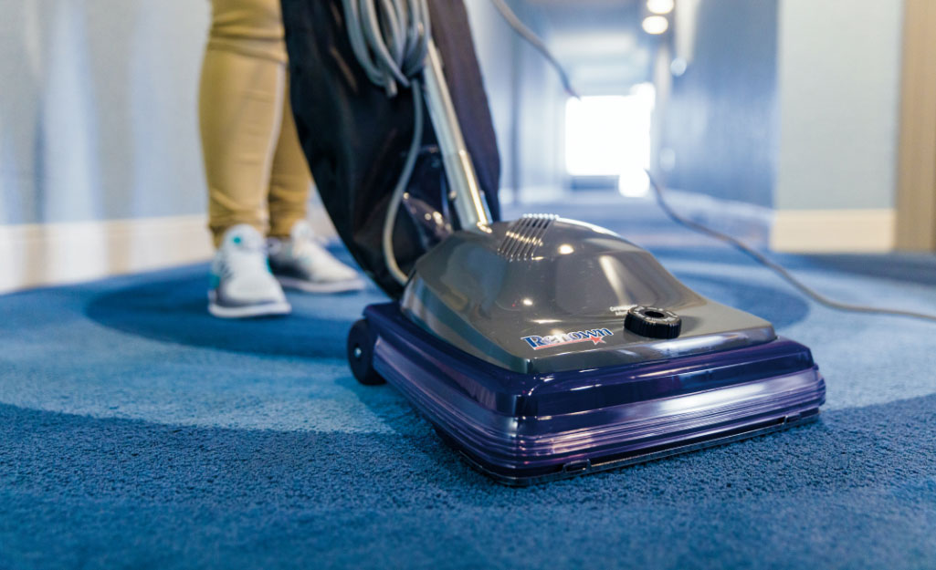 Personnel vacuums commercial carpet