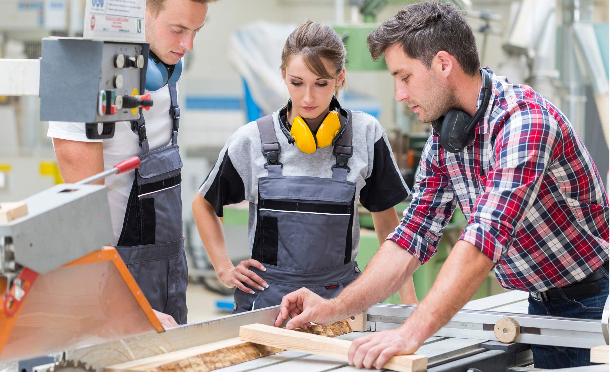 An instructor teaches carpentry at a trade school. An instructor teaches carpentry at a trade school.