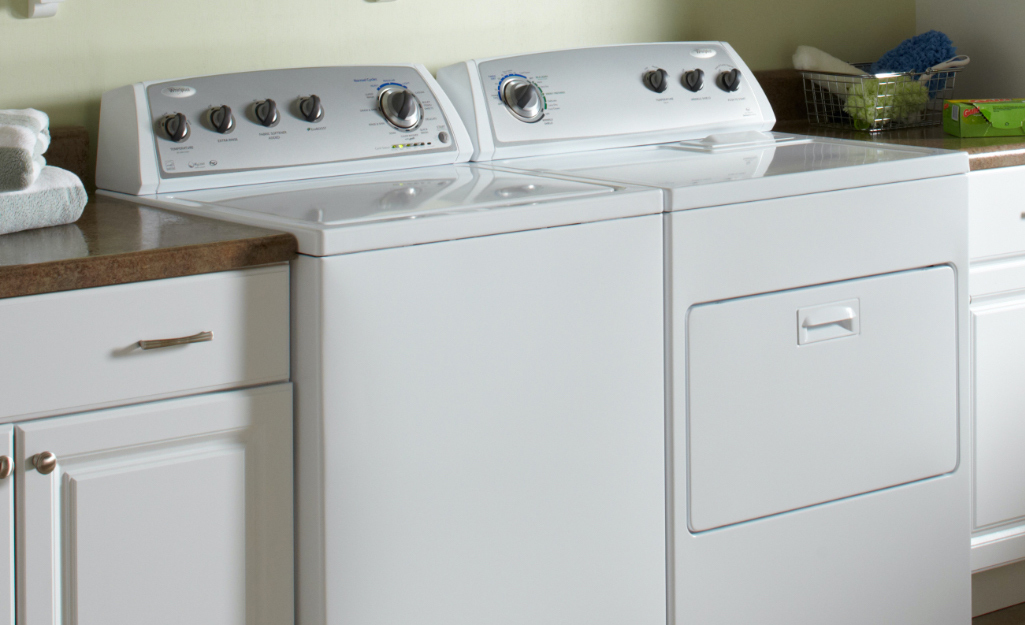 A Whirlpool washer/dryer in a laundry room.