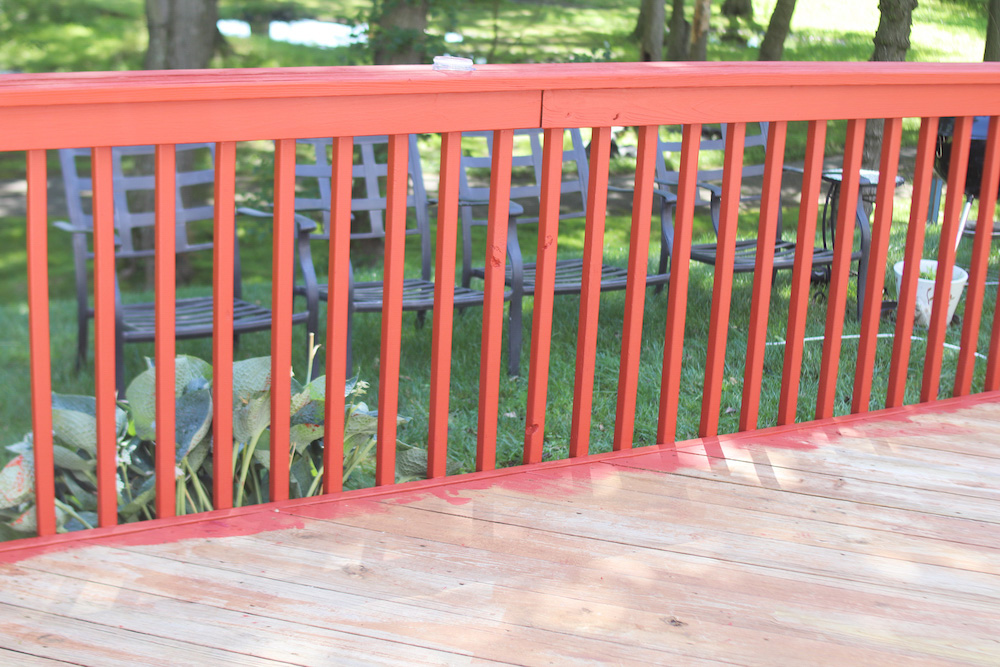 The railing on a deck fully stained.