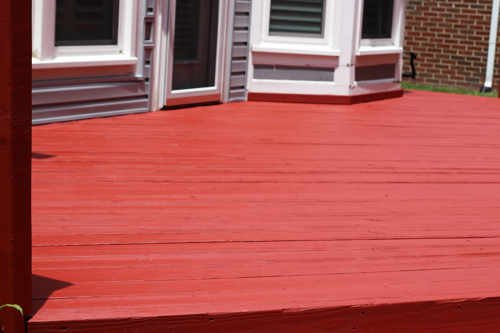 A fully stained deck floor in Olympic Navajo Red.