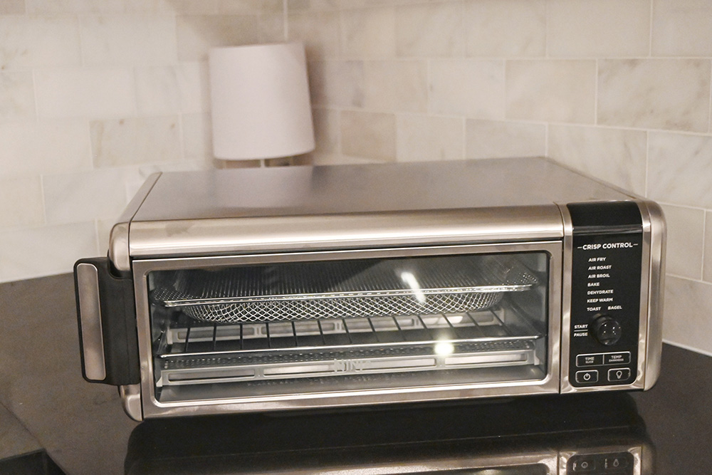 A Ninja Air Fry Oven sitting on a countertop.