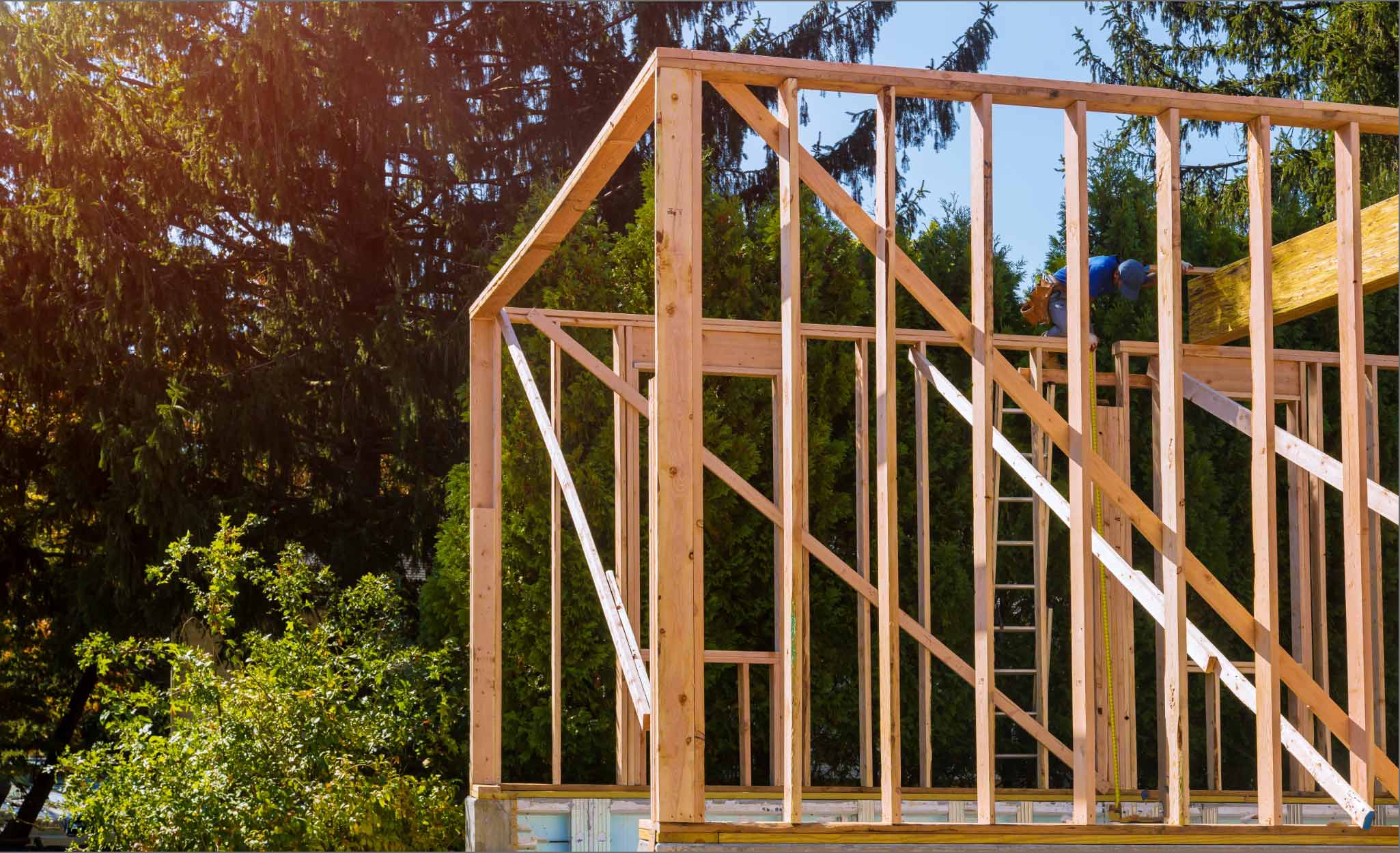Construction Worker Builds Wood Frame Home Addition