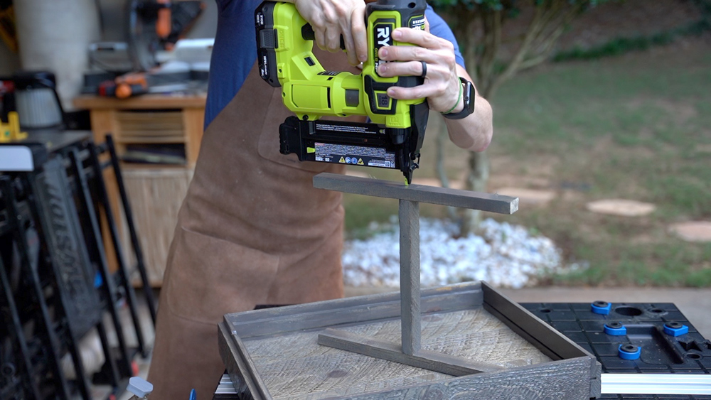 Man using nailer to assemble dividers. Man using nailer to assemble dividers.