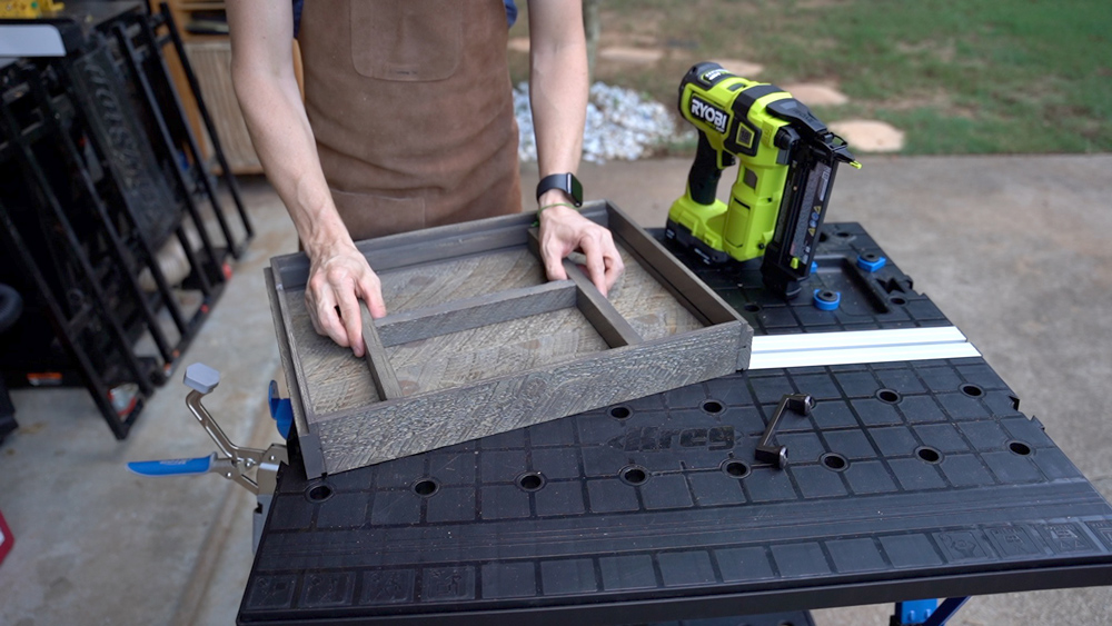 Man assembling dividers in a tray. Man assembling dividers in a tray.