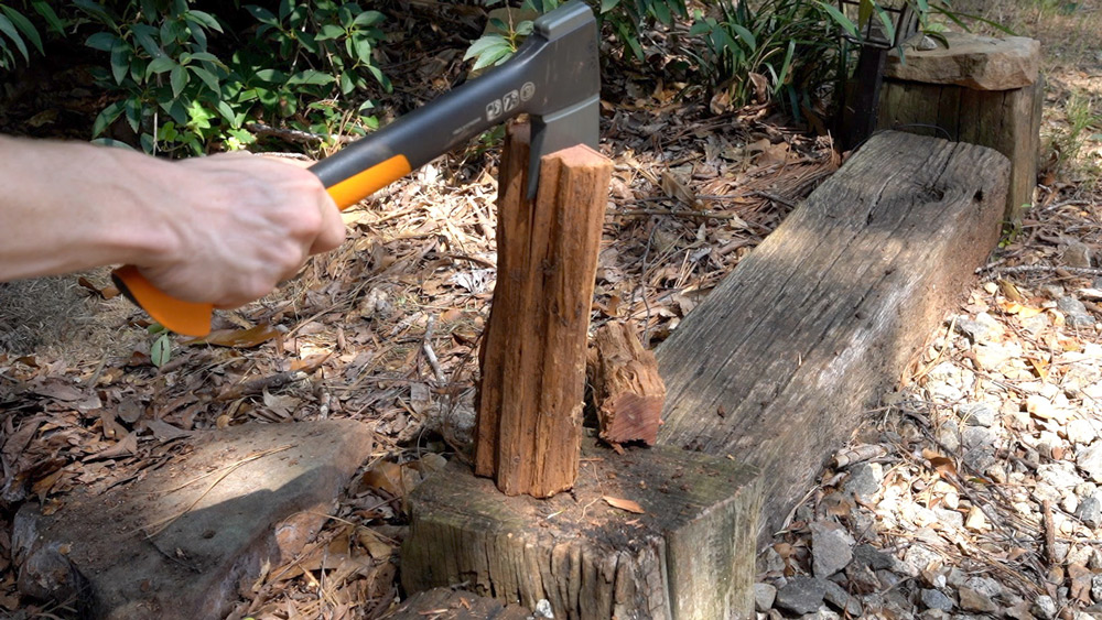 Man splitting wood with an axe. Man splitting wood with an axe.