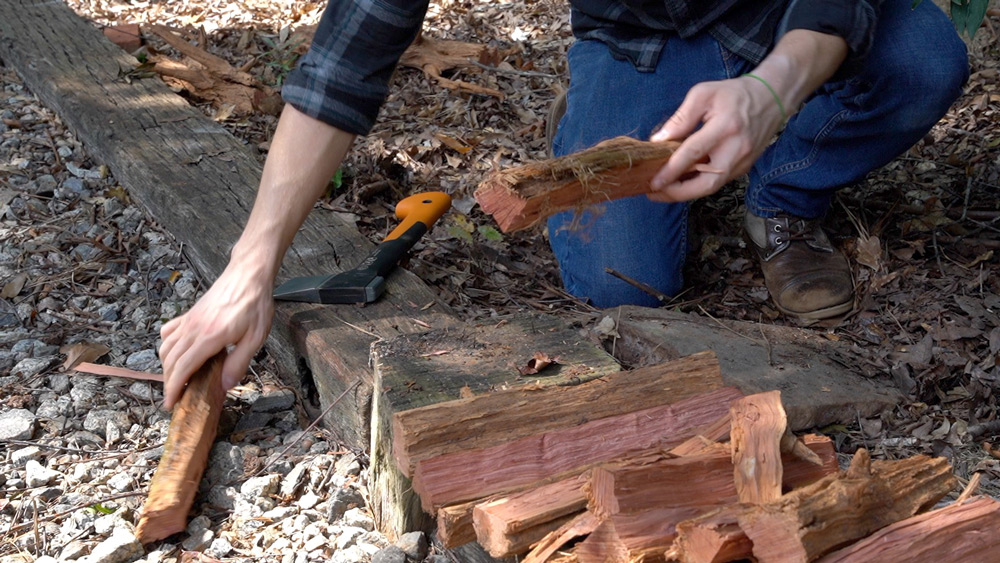 Man collecting split wood. Man collecting split wood.