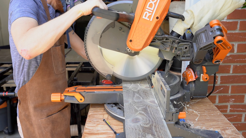 Man preparing to use a miter saw. Man preparing to use a miter saw.