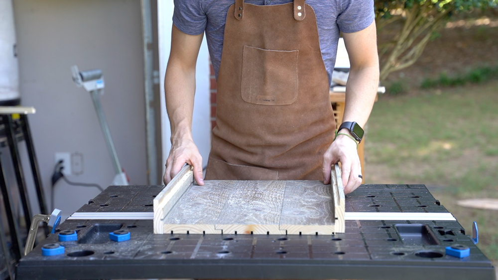Man holding wood together and building sides. Man holding wood together and building sides.